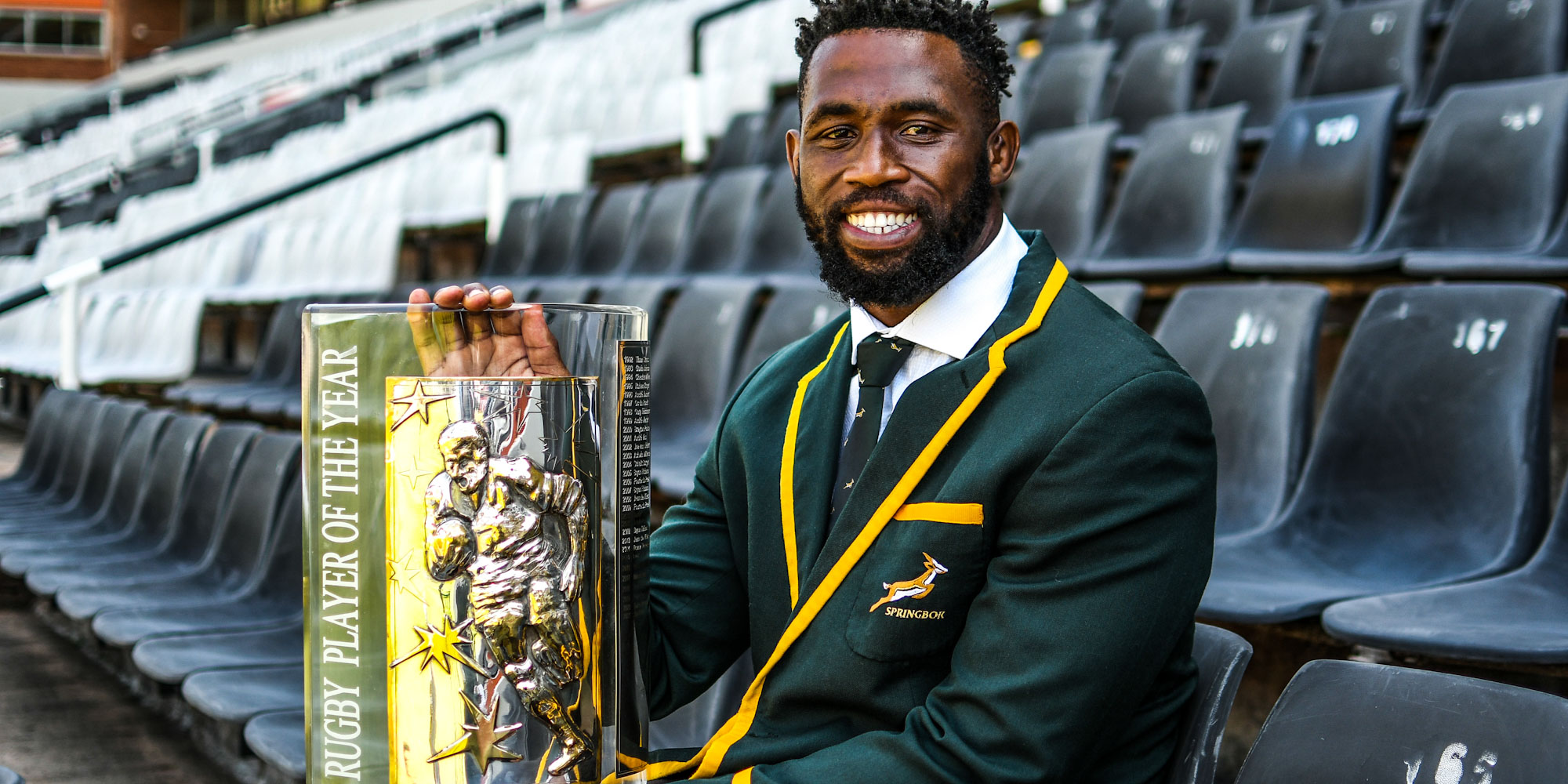 A smiling Siya Kolisi with the SA Rugby Player of the Year trophy.